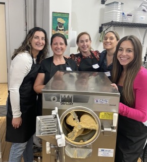 Guests churning ice cream in a commercial batch freezer